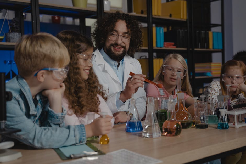Students in a science class watch a chemistry experiment with colorful liquids